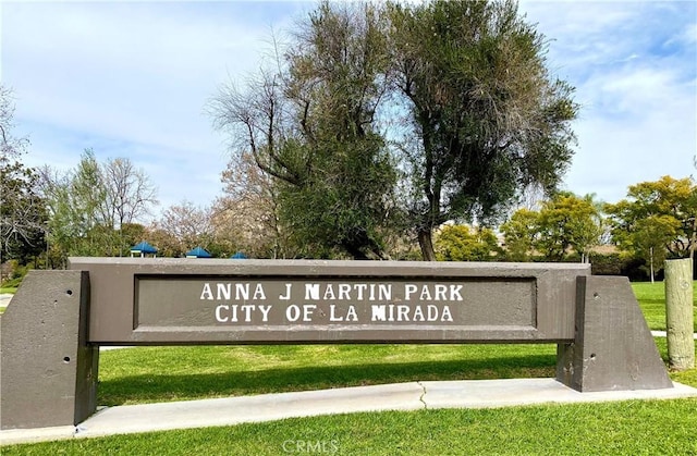 community / neighborhood sign with a lawn