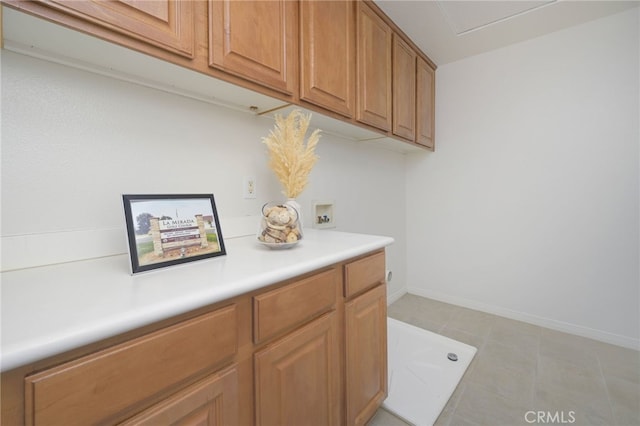 interior space with washer hookup, cabinet space, and baseboards