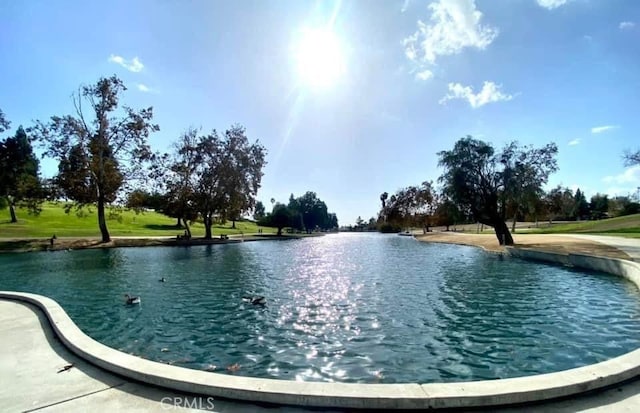 view of swimming pool with a water view