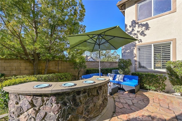 view of patio featuring an outdoor hangout area and fence