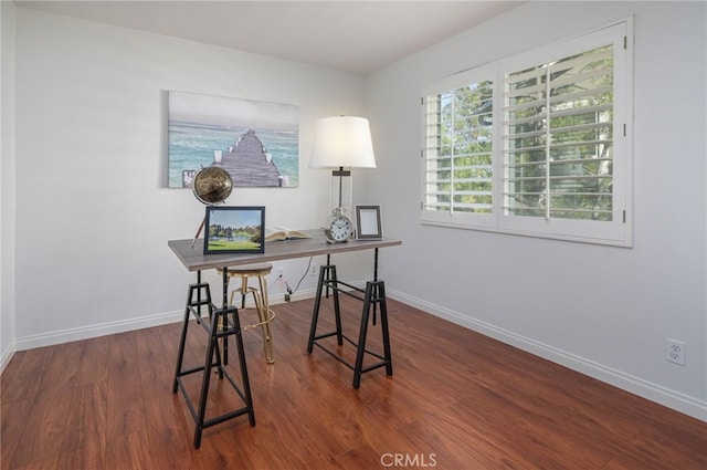 office area with baseboards and wood finished floors