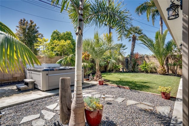 view of yard with a patio, central AC unit, a fenced backyard, and a hot tub