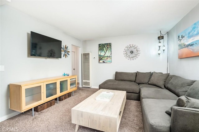 living area featuring baseboards and carpet