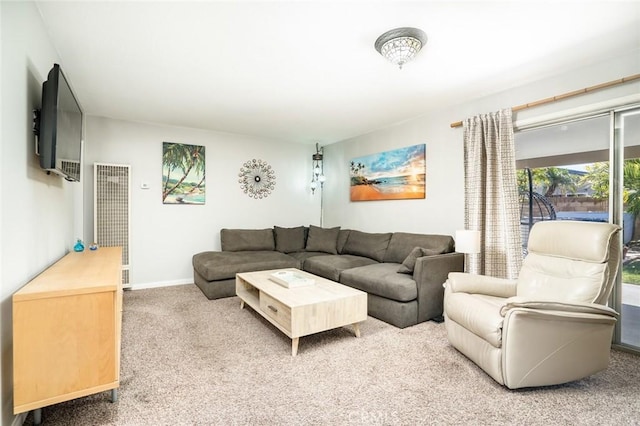 carpeted living room with baseboards