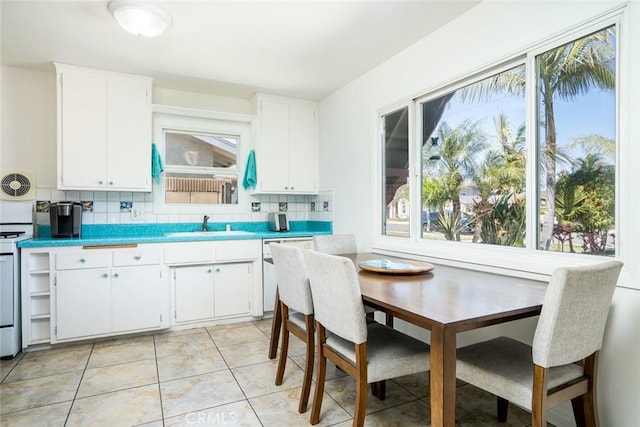 kitchen featuring decorative backsplash, plenty of natural light, visible vents, and white dishwasher