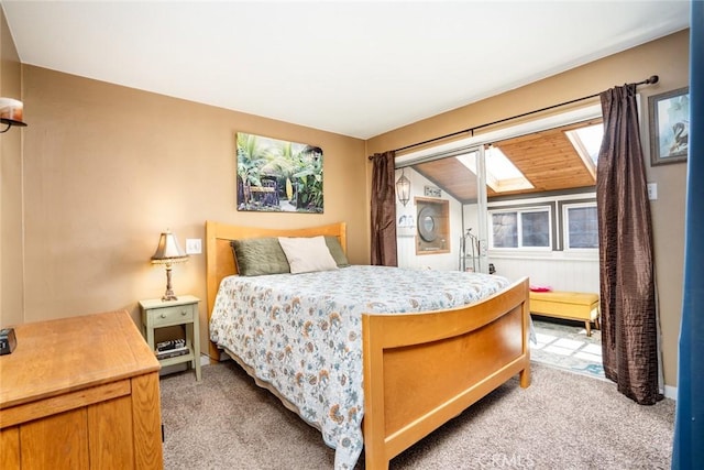 bedroom featuring lofted ceiling with skylight and light carpet