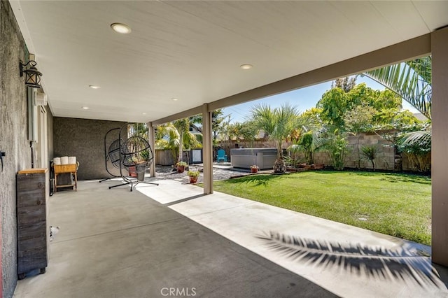 view of patio / terrace featuring a fenced backyard and a hot tub