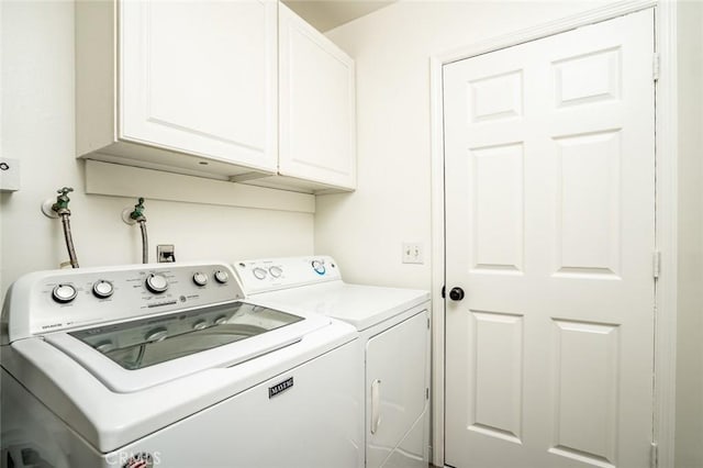 washroom with cabinet space and washing machine and clothes dryer