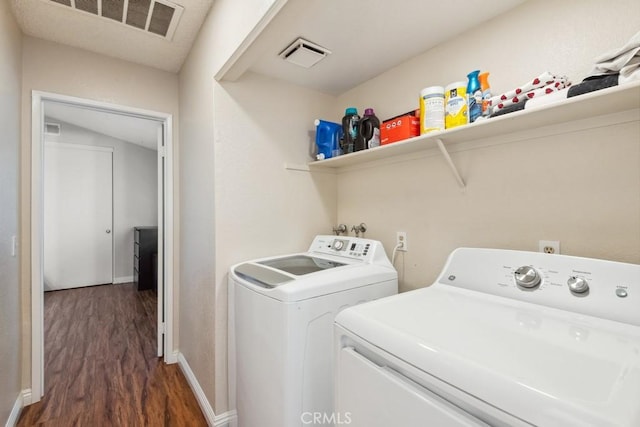 laundry room with visible vents, dark wood-style flooring, laundry area, and washer and clothes dryer