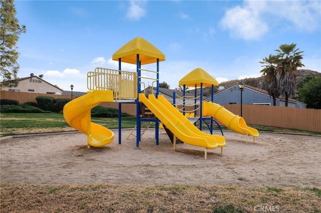 community jungle gym featuring fence