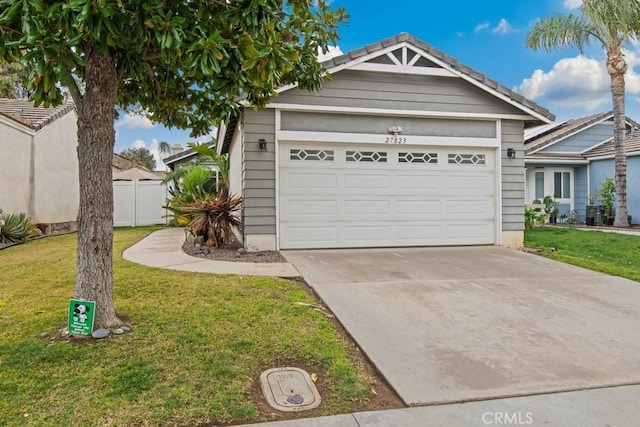 ranch-style house featuring driveway, an attached garage, a front lawn, and fence