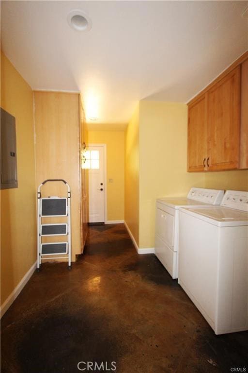 washroom featuring electric panel, cabinet space, baseboards, and separate washer and dryer