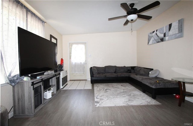 living room featuring lofted ceiling, a ceiling fan, and wood finished floors