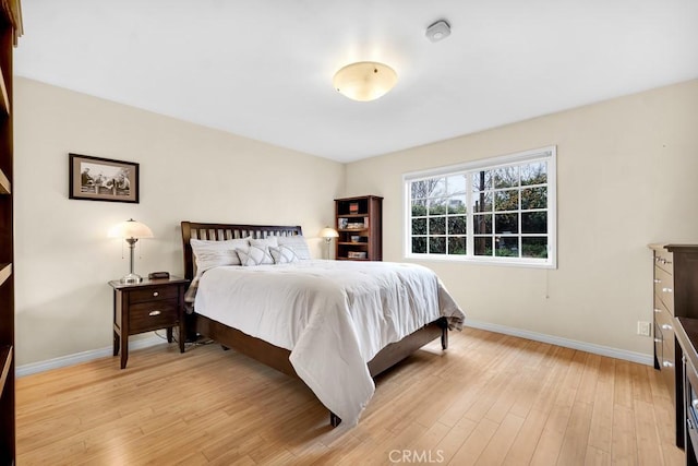 bedroom featuring light wood-type flooring and baseboards