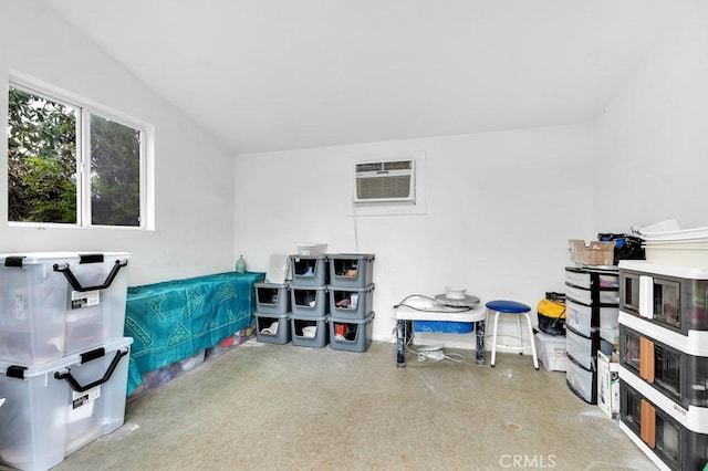 misc room with concrete flooring and a wall mounted AC