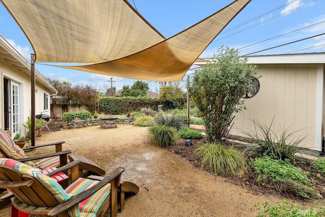 view of patio featuring a fire pit and fence