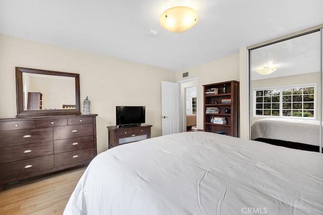 bedroom with visible vents and light wood finished floors