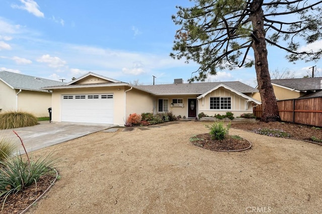 ranch-style house featuring concrete driveway, fence, a garage, and stucco siding