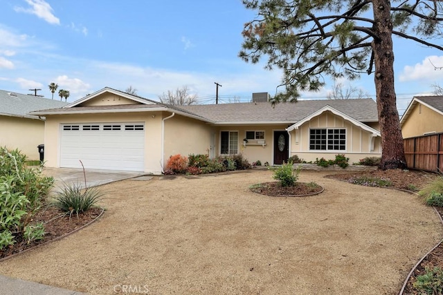 ranch-style house featuring stucco siding, driveway, a garage, and fence