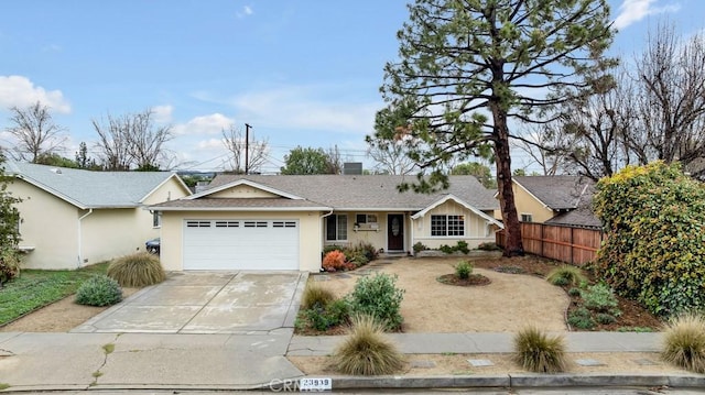 ranch-style house with fence, roof with shingles, stucco siding, concrete driveway, and a garage