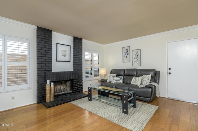 living room featuring a fireplace, crown molding, and hardwood / wood-style floors