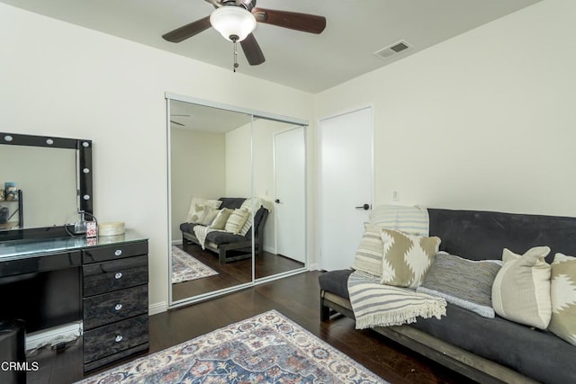 bedroom with ceiling fan, visible vents, a closet, and wood finished floors