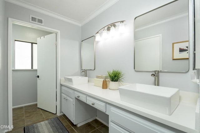 bathroom with tile patterned flooring, crown molding, visible vents, and a sink