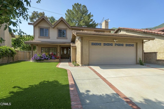 view of front facade with stucco siding, driveway, fence, a front yard, and an attached garage