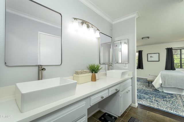 ensuite bathroom with a sink, ensuite bath, ornamental molding, and double vanity