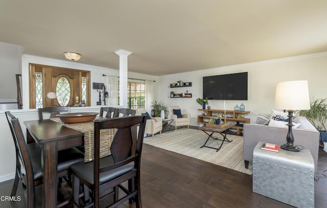 dining area featuring decorative columns, ornamental molding, and dark wood-style flooring