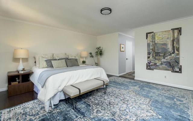 bedroom featuring crown molding, baseboards, and wood finished floors