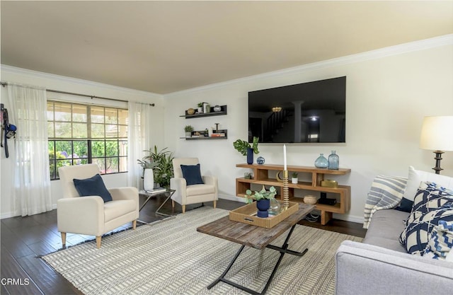 living area with wood finished floors, baseboards, and ornamental molding