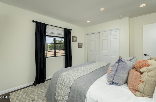 bedroom with a closet, recessed lighting, and baseboards