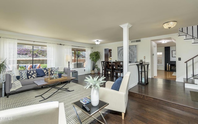 living room with visible vents, stairs, ornamental molding, hardwood / wood-style floors, and ornate columns