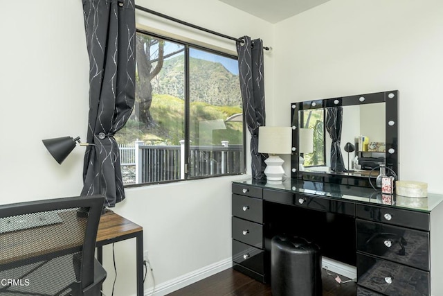 home office featuring wood finished floors and baseboards