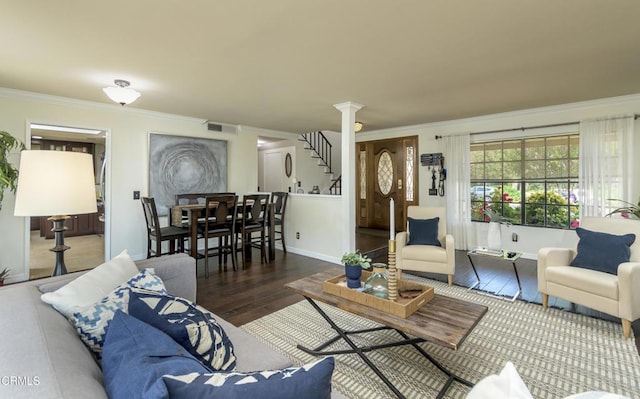 living room featuring crown molding, wood finished floors, visible vents, and baseboards