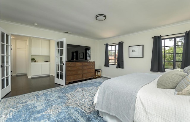 bedroom with crown molding, french doors, dark wood-style flooring, and visible vents