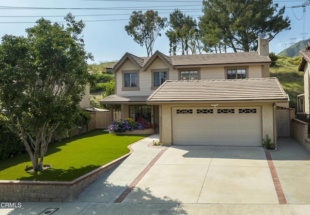 traditional home with fence, a tile roof, a front yard, a chimney, and driveway