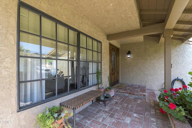 entrance to property with stucco siding