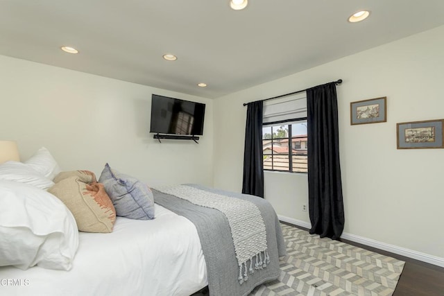 bedroom with recessed lighting, baseboards, and wood finished floors