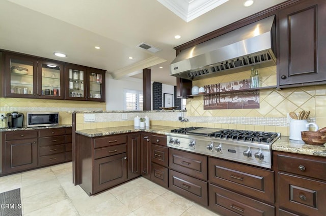 kitchen featuring visible vents, stainless steel appliances, crown molding, and wall chimney range hood