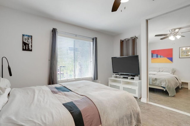 bedroom featuring baseboards, light carpet, and a ceiling fan