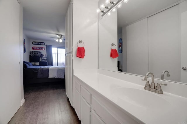 bathroom featuring ensuite bathroom, vanity, wood finished floors, and a ceiling fan