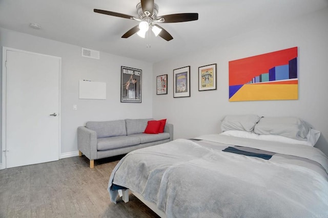 bedroom featuring wood finished floors, visible vents, and ceiling fan