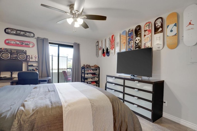 bedroom with wood finished floors, a ceiling fan, and baseboards