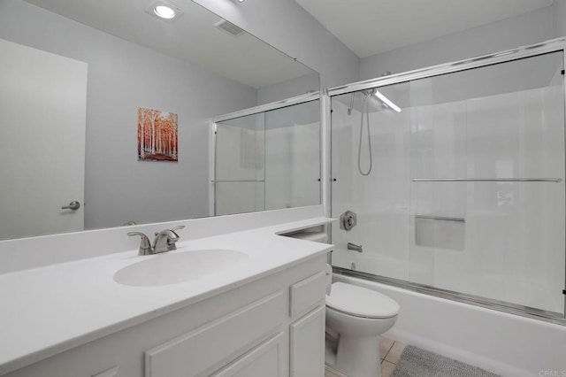 full bathroom with visible vents, toilet, tile patterned floors, combined bath / shower with glass door, and vanity