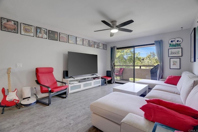 living room featuring wood finished floors and a ceiling fan