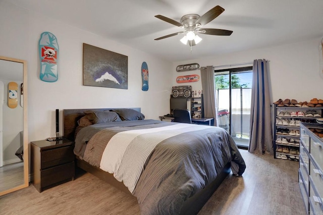 bedroom with light wood-type flooring, a ceiling fan, and access to outside