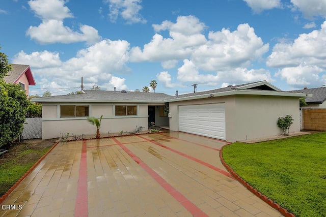 single story home featuring stucco siding, a garage, driveway, and fence