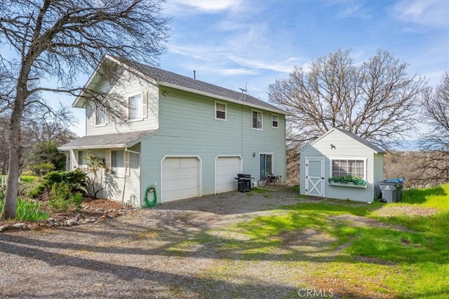 exterior space with driveway, an outdoor structure, and a garage